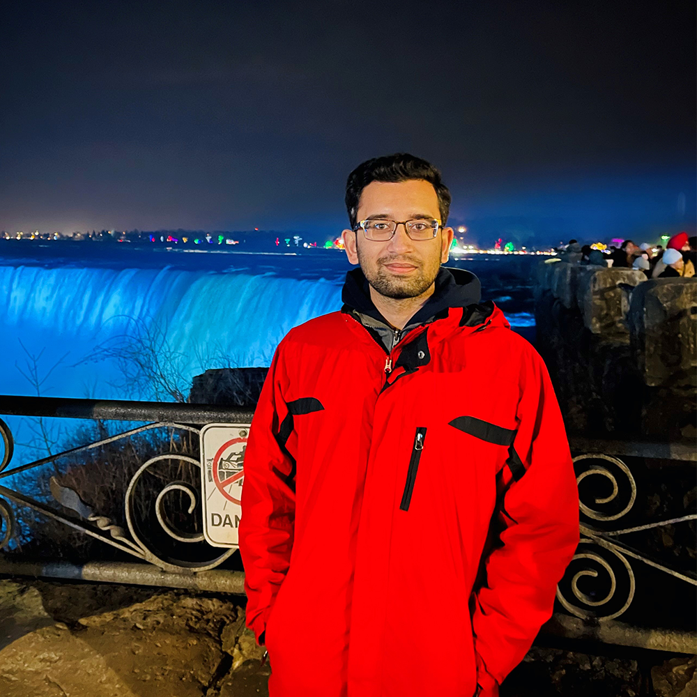 img des: Ahsan standing in front of large falls.